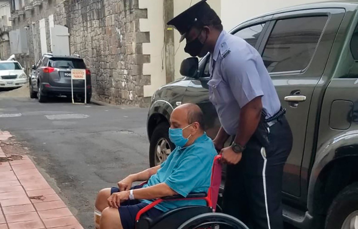 Mehul Choksi is taken in a wheelchair to the Magistrates court by police after his arrest.